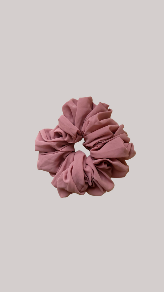 A chiffon scrunchie designed for wearing discreetly under a hijab or undercap. The scrunchie is made from soft and lightweight chiffon fabric, ensuring comfort and minimizing friction against the skin.