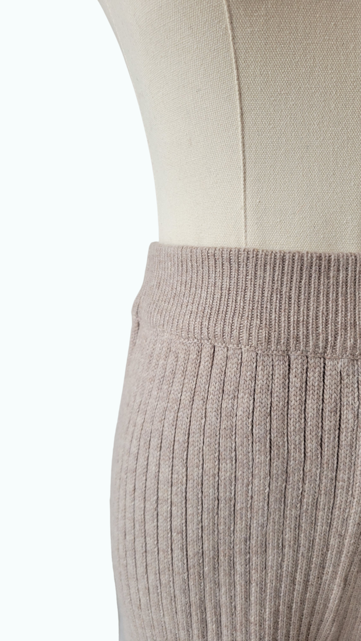 A chic two-piece knit co-ord set in 'Wheat', a beige colour. The set includes a comfy sweater with a relaxed fit and matching knit pants. Perfect for a stylish and cozy look.